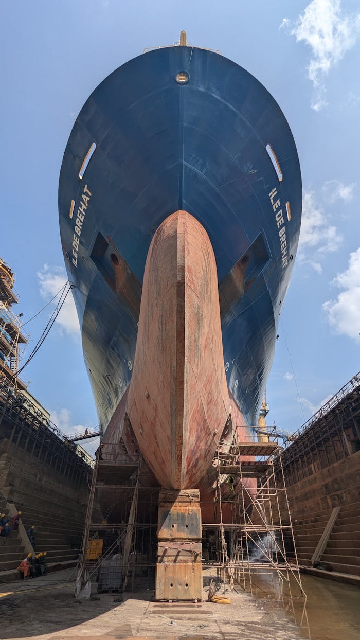 why-choose-us Impressive view of a large ship hull in a Sri Lankan dry dock, showcasing maritime engineering.