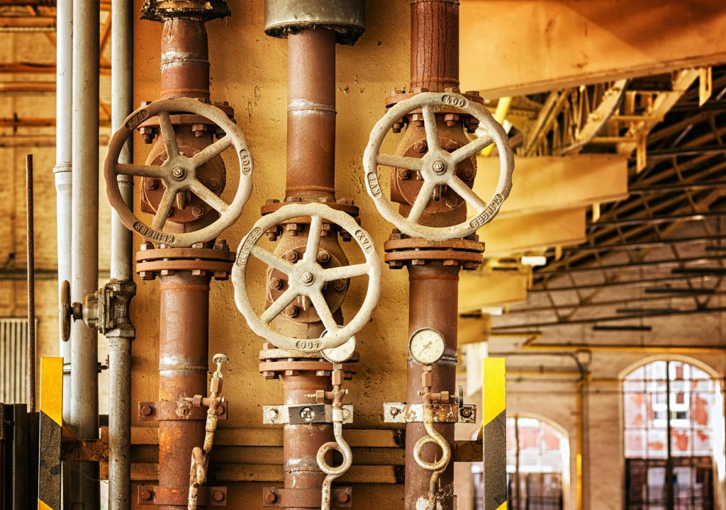 pexels photo 357440 357440 Close-up of rusty industrial pipes and valves, showcasing aging machinery in a factory setting.